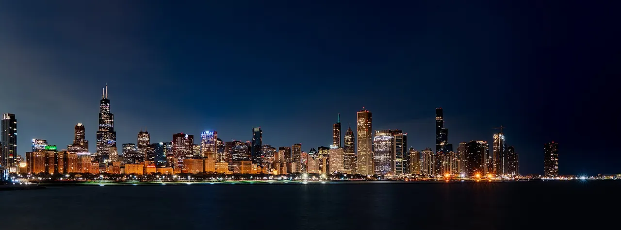 Chicago’s skyline across Lake Michigan before sunrise on March 15, 2026.
